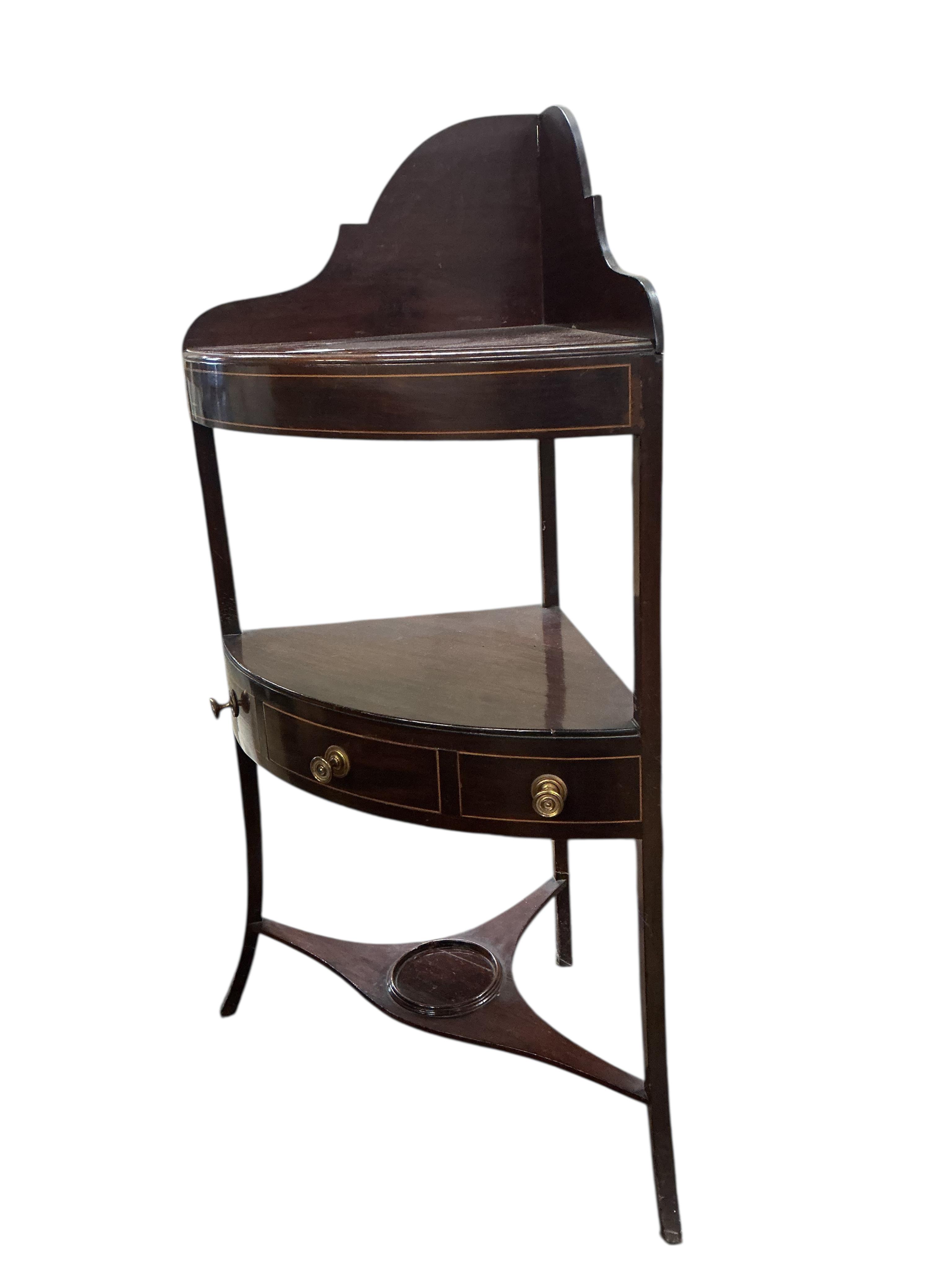A George III inlaid mahogany bow fronted corner washstand, width 56cm, depth 37cm, height 103cm